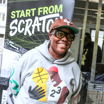 Attendee smiling in front of the Start From Scratch banner