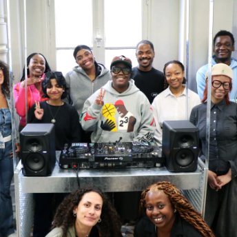 Group photo of attendees behind the decks at Pablo's T-Shirt Factory
