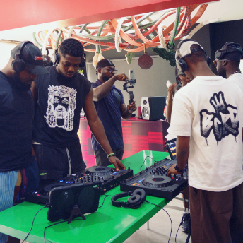 Attendees taking turns on the decks at the Homecoming concept store