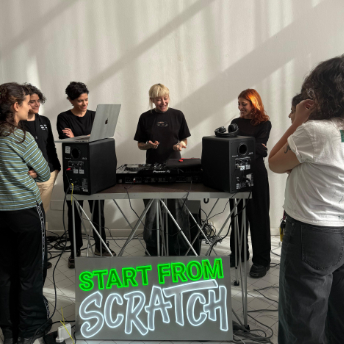 Attendees gathered at the decks behind a Start From Scratch sign