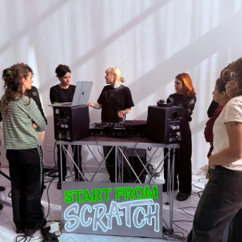 Group at the decks in front of the Start From Scratch sign