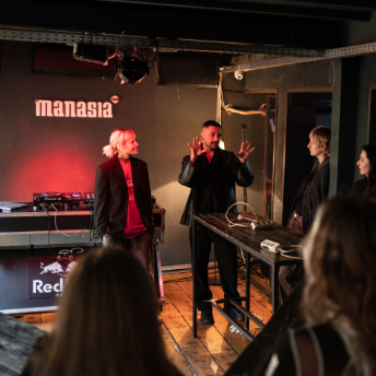 Host introducing the session on stage at Manasia HUB