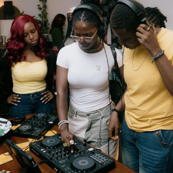 Three attendees mixing together in headphones