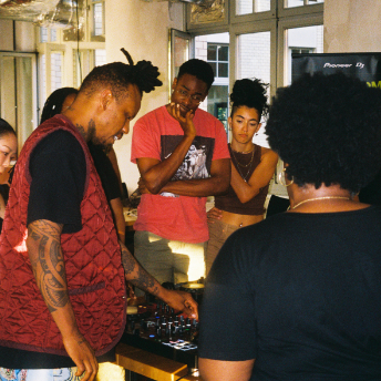 Attendees gathered around the equipment at House of Color