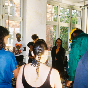 Workshop group listening to a set