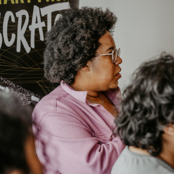 Attendee listening in front of a Start From Scratch poster at FFS, A-SIDE