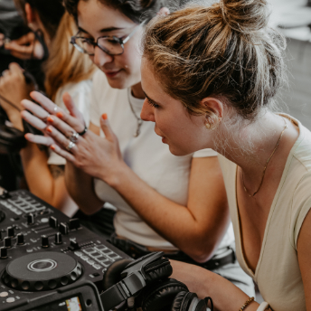 Two attendees studying the controller layout together