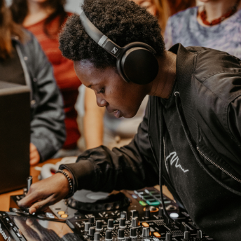 Attendee in headphones concentrating on the mixer