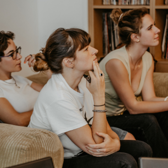 Attendees listening from the sofa during the session
