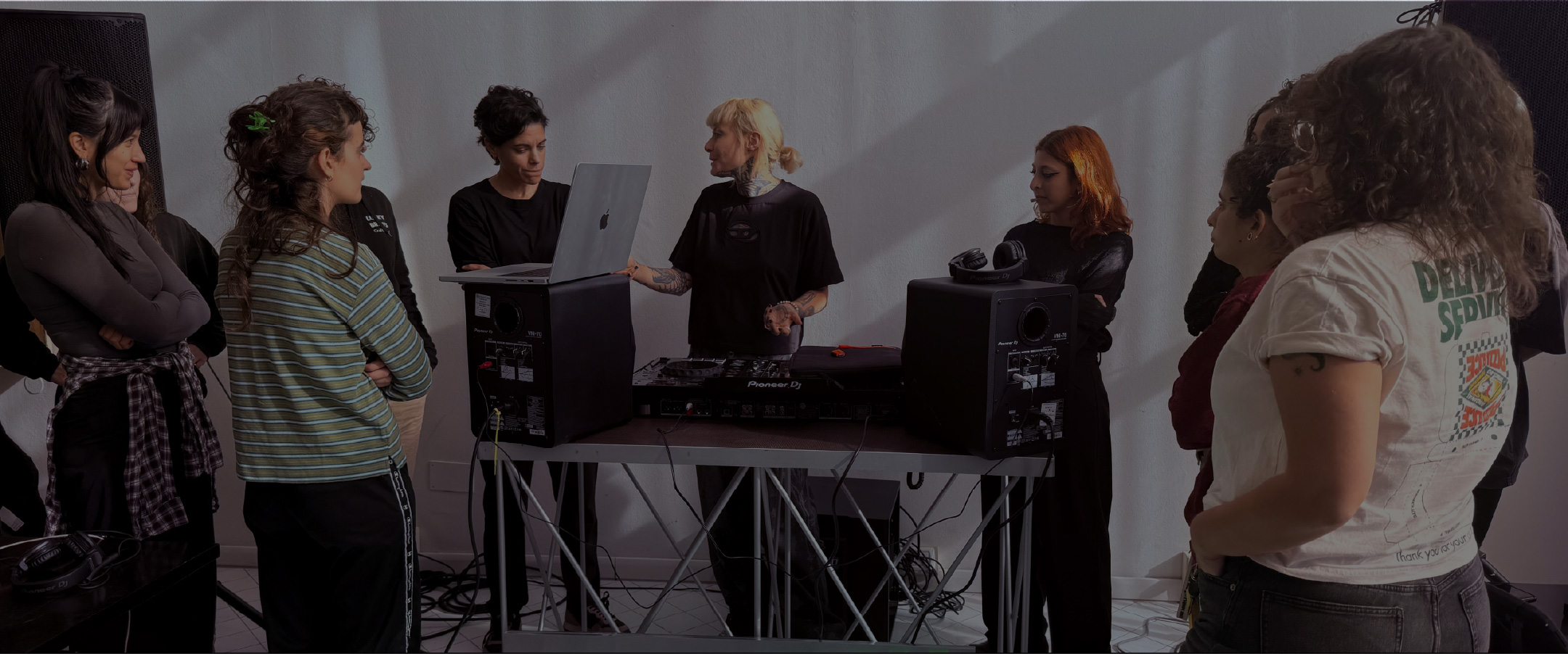 Attendees gathered around DJ decks at a Start From Scratch workshop